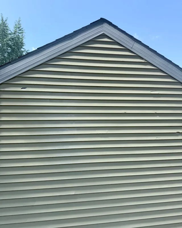 The same vinyl siding gable, clean, after a JetKing house wash