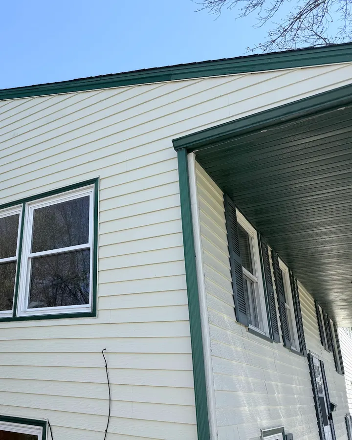 Cream siding with green trim after a JetKing house wash
