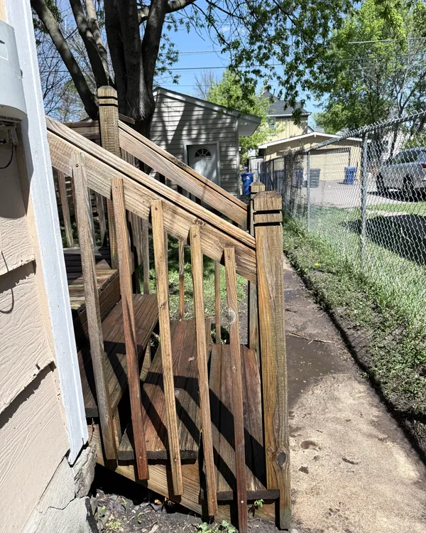 The same deck stairs and railing lighter after JetKing deck washing