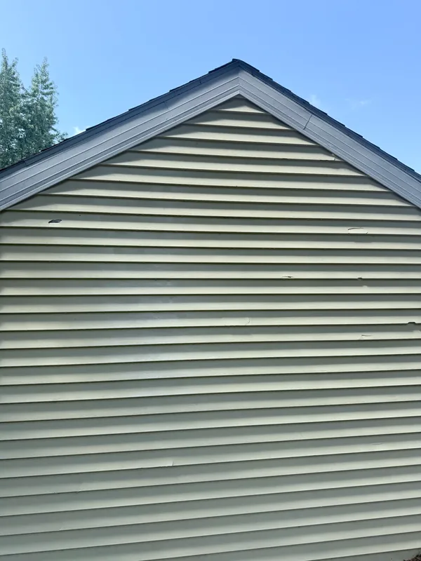 Clean siding gable under a blue sky