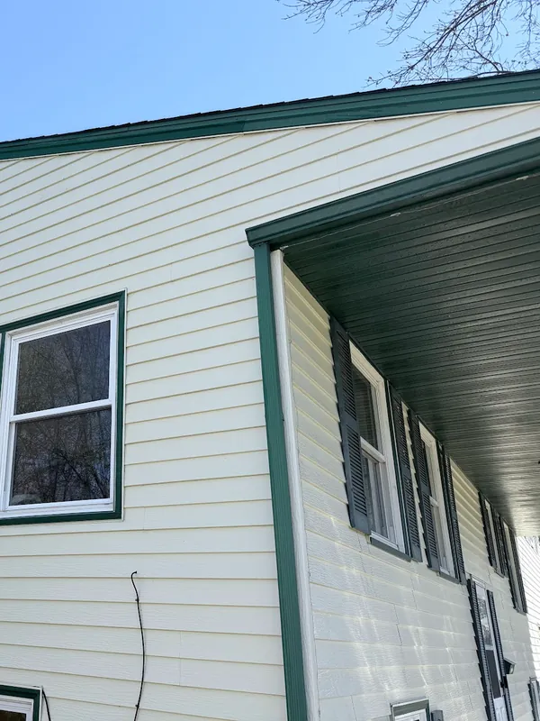 Cream siding with green trim after washing