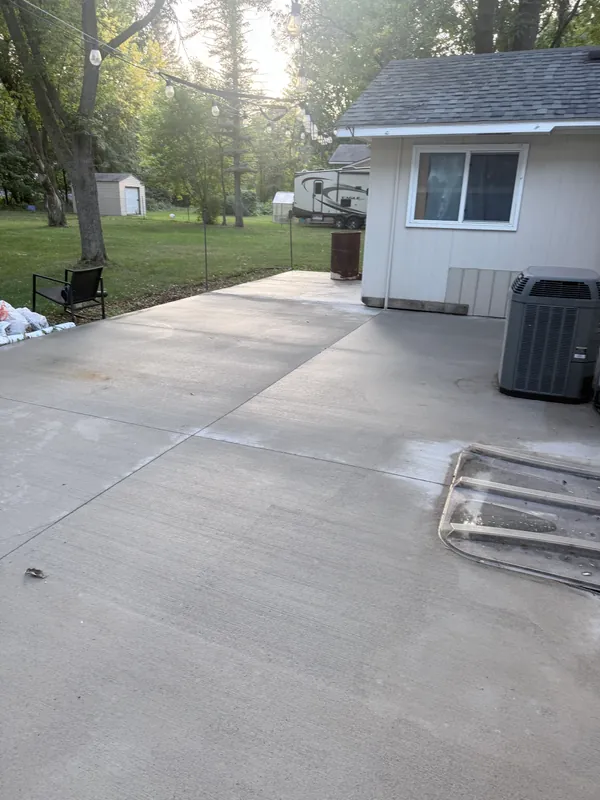 Clean concrete patio behind a house